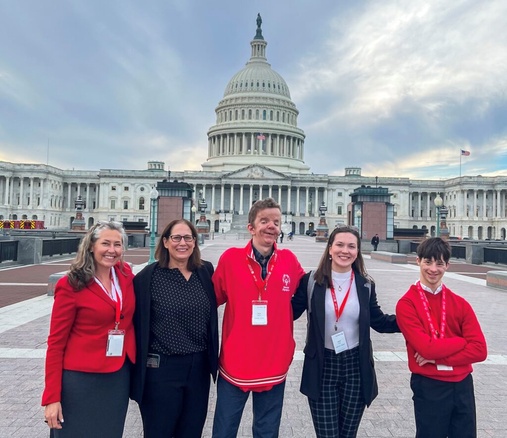 Special Olympics athletes and staff stand in front of the Capitol Building in Washington D.C.